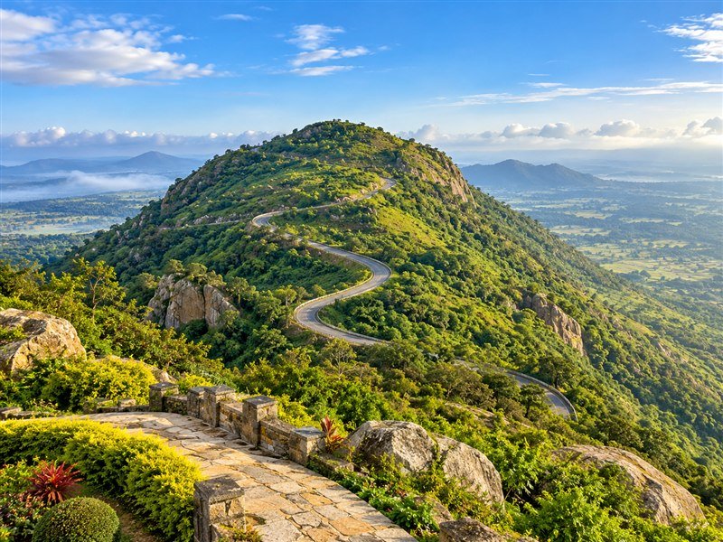 Green hills and a winding road around Nandi Hills